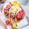 Barburrito tacos with nachos, salsa and lime wedges