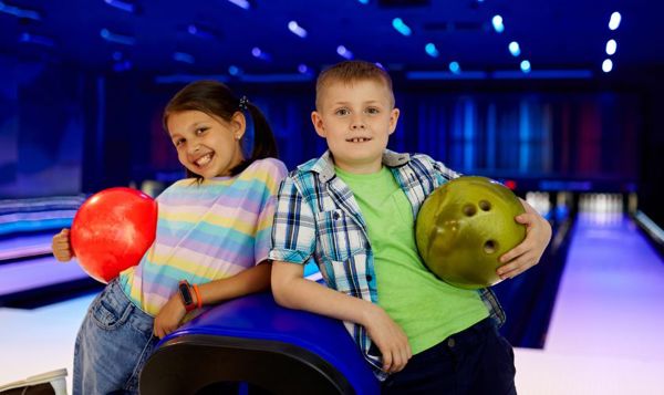 Kids enjoying bowling on a rainy day