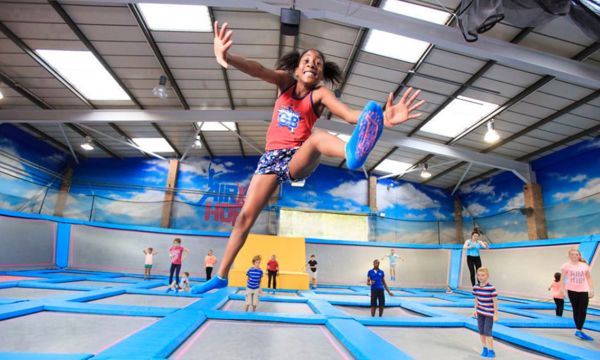 Kids enjoying a trampoline park on a rainy day