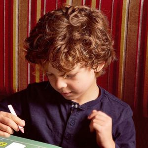 Child colouring at the table in Hard Rock Cafe